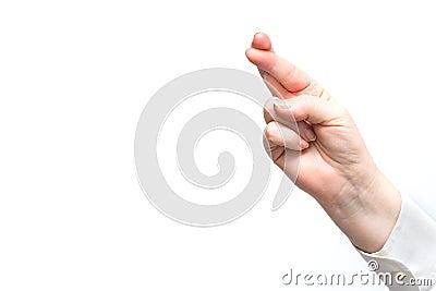 Women`s hand in a gesture of `fingers crossed` meaning success, faith,hope,happiness in achiving the goal. Place for text Stock Photo