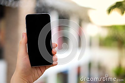 Women`s hand using mobile phone black screen for search data, Stock Photo