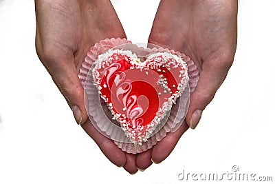 Women`s hands with a heart shaped cake Stock Photo