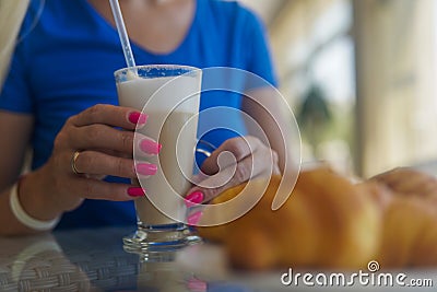 Women`s hands hold a glass of cappuccino. close-up Stock Photo