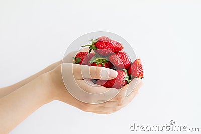 Women`s hands holding a large handful of ripe strawberries Stock Photo