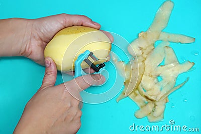 Women`s hands peeling potatoes Stock Photo