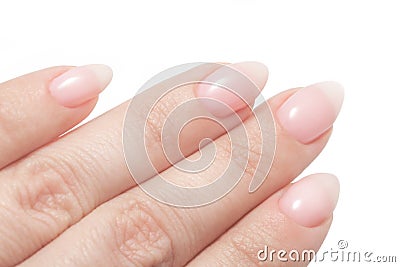 Women`s hands with perfect Nude manicure. Nail Polish is a natural pale pink shade. Isolated on white Stock Photo