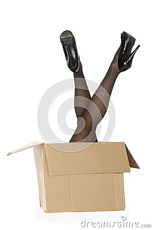 Women's legs sticking out of the box Stock Photo