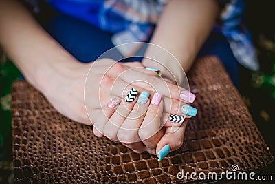 Women's manicure on a background of crocodile skins Stock Photo