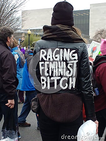 Women`s March on Washington DC, Woman Walking Through the Crowd Wearing a Jacket Labeled `Raging Feminist` Editorial Stock Photo