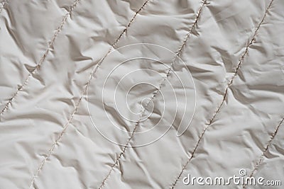 women's padded white soft jacket as background, of soft light fabric Stock Photo