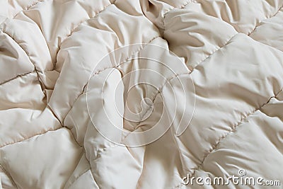 women's padded white soft jacket as background, of soft light fabric Stock Photo