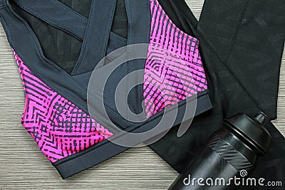 Women`s sports bra and Black Bicycle water bottle. Sport accessories and fashion. Stock Photo
