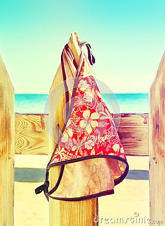 Women's swimsuit hanging on a rope on the fence Stock Photo