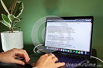 A women searches on her computer ` How can you afford to buy a home in Vancouver`. Real estate in this expensive city is over 1 mi Editorial Stock Photo