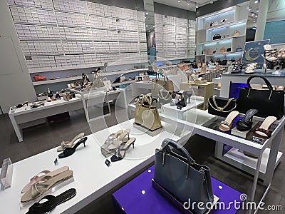 Women shoes and handbags on display for sale in a fashion boutique. Shoes and purses in a store in Dubai Editorial Stock Photo