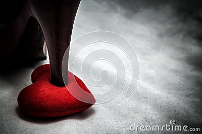 women shoes stomp on broken heart in dark tone., unrequited love Stock Photo
