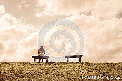 A women sitting alone on a bench waiting for love Stock Photo