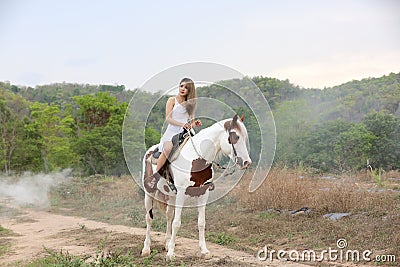 Women on skirt dress Riding Horses On field landscape Against forest. Stock Photo