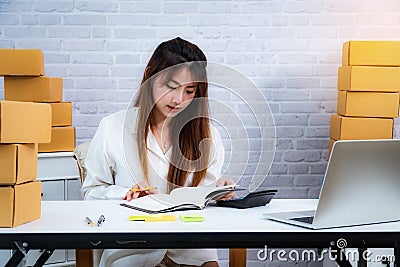 Women small business owner working at home with packing box on workplace. online shopping SME entrepreneur or freelance working Stock Photo