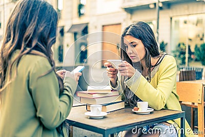 Women with smartphones in a bar Stock Photo