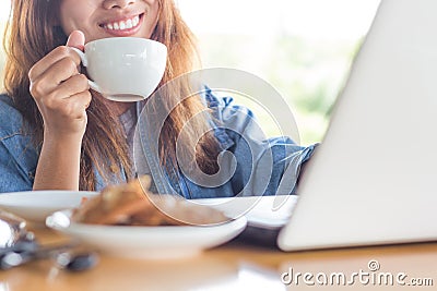 Women smile drink coffee and use computer Stock Photo