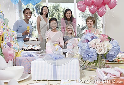 Women Smiling At Baby Shower Stock Photo