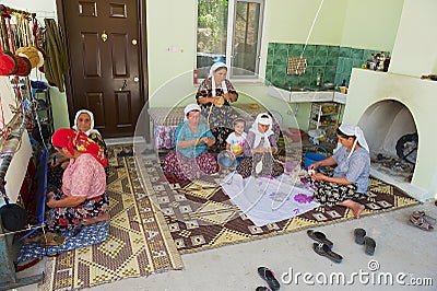 Women spin wool for carpet production in Karacahisar, Turkey. Editorial Stock Photo