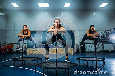 Women on trampoline in motion, fitness training Stock Photo