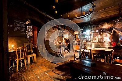 Women talking inside the old style bar with vintage furniture Editorial Stock Photo