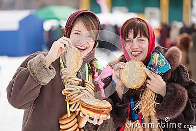 Women tasting pancake during Shrovetide Stock Photo