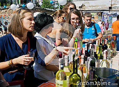 Women tasting white wine in outdoor bar Editorial Stock Photo