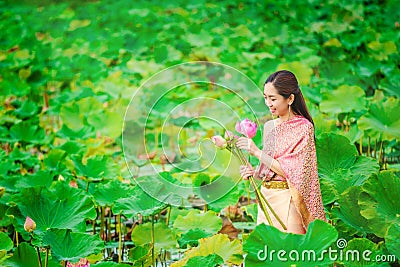 Women in Thai dresses collect lotus flowers boat Stock Photo