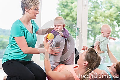 Women and their babies in mother-child gymnastic course Stock Photo