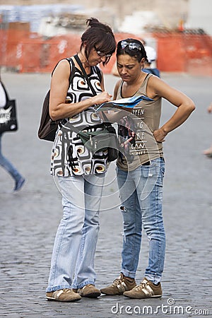 Women tourists orienteering with map Editorial Stock Photo