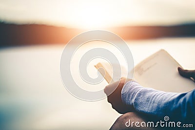 Women tourists read books in quiet nature. Stock Photo