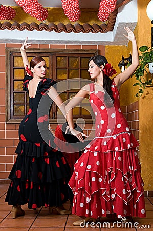 Women in traditional flamenco dresses dance during the Feria de Abril on April Spain Stock Photo