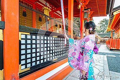 Women in traditional japanese kimonos at Fushimi Inari Shrine in Kyoto, Japan Stock Photo