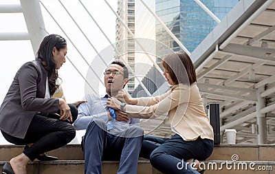 Women try to help her friend having severe chest pain as heart attack in the city background Stock Photo