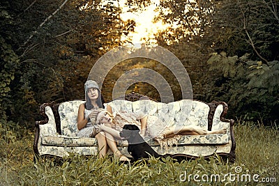 Women in twenties fashion on vintage couch Stock Photo