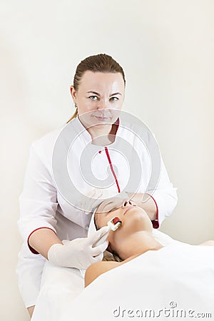 The woman undergoes the procedure of medical micro needle therapy Stock Photo