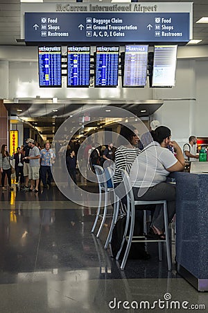 Women use charging stations at airport Editorial Stock Photo