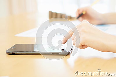 A Women using her Smartphone in office Stock Photo