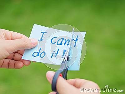 Women using scissors to remove the word can`t to read I can do it concept for self belief, Stock Photo