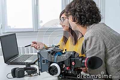 Woman video editor and young assistant using graphic tablet Stock Photo