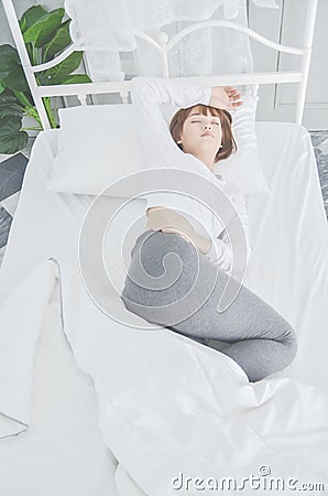 Women wear white pajamas on the mattress. Stock Photo