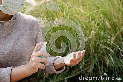 The women wearing the mask and use alcohol spray, Make a symbol fight in disaster covid19 Stock Photo