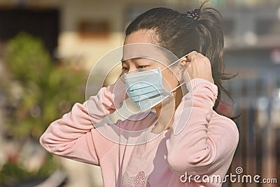 Women wearing medical masks to prevent coronavirus infections in the community Stock Photo