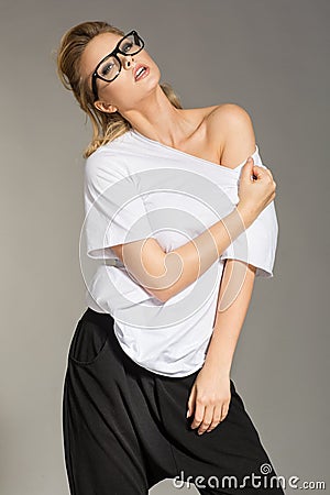 Women in white blouse and black trousers on the grey background Stock Photo