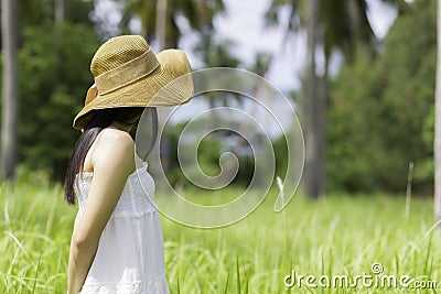 Women white dress stand in the garden Stock Photo