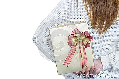 Women in white hiding a gift behind her back on white background Stock Photo