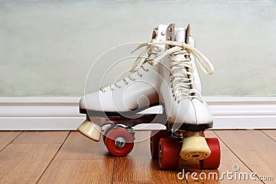 Women white quad roller skates on wood floor Stock Photo