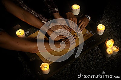 Women witches with spiritual board ouija summoning ghosts Stock Photo