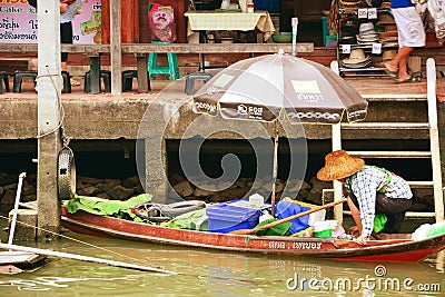 Women on wooden boats busy ferrying people at Amphawa floating m Editorial Stock Photo